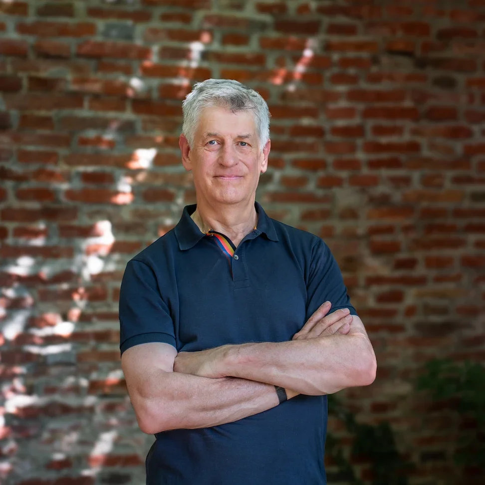 Tim Clark, meditation teacher, smiling portrait against a calm background
